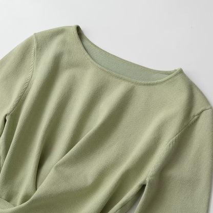 Long sleeved round neck asymmetrical hem knitted top